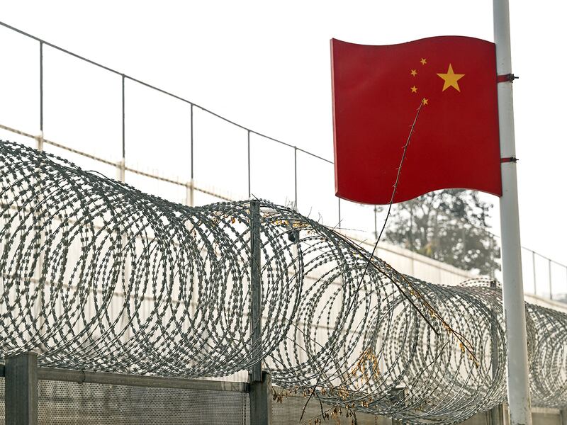 A Chinese flag flies over the border wall between China and Myanmar in Ruili, west Yunnan Province on Jan. 14, 2023.